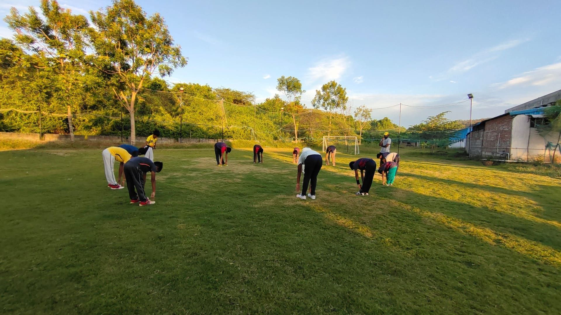 Academy juniors doing morning mobility drills on the turf