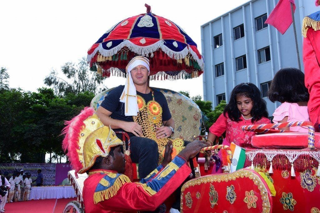 Shane Watson on a ceremonial chariot under a royal umbrella