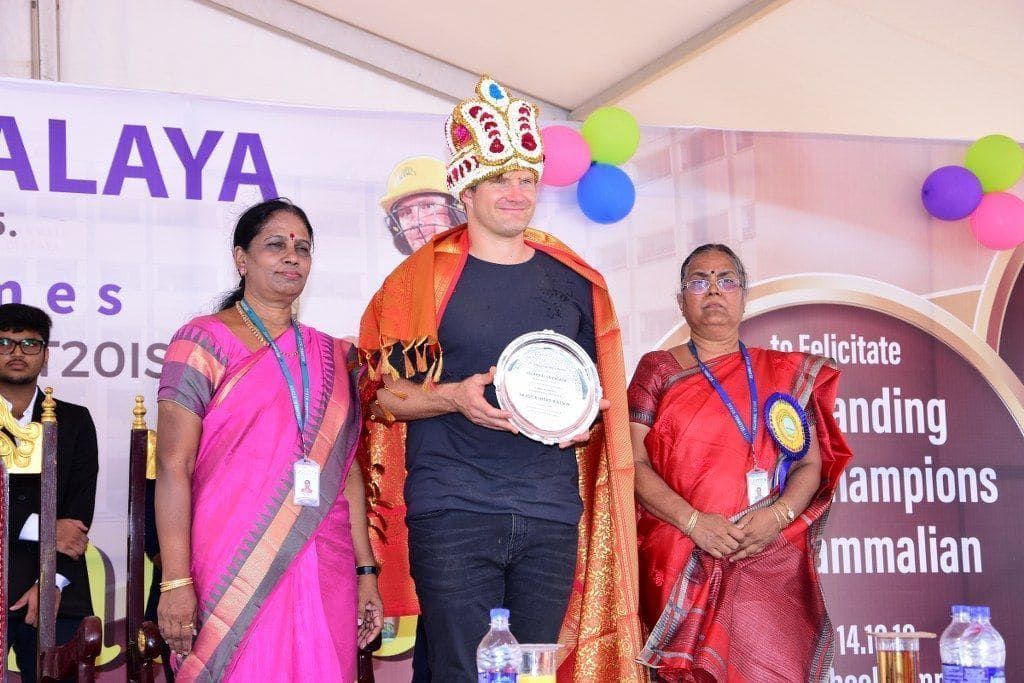 Shane Watson receiving a felicitation crown and plaque
