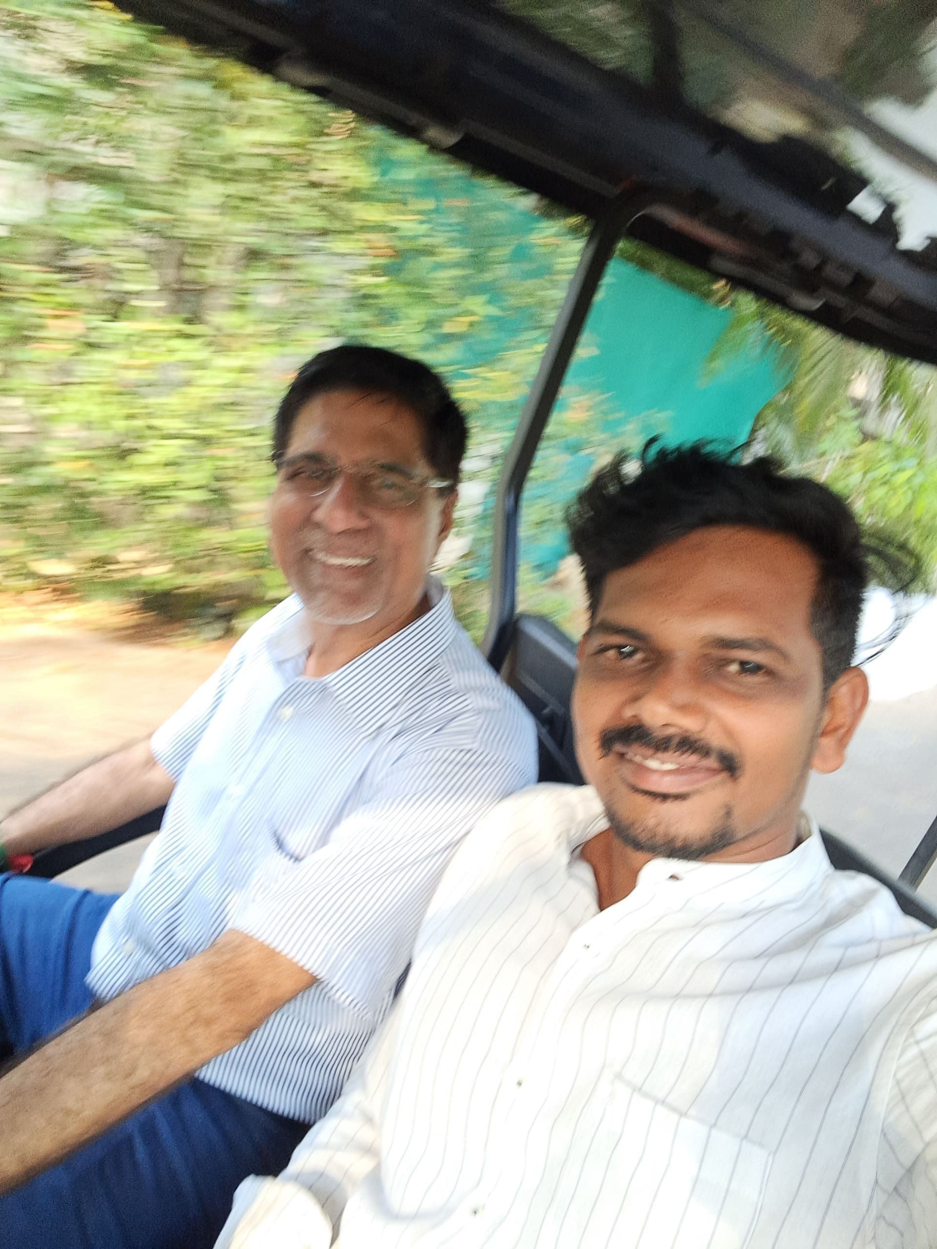 Leadership team riding a golf cart at a resort offsite